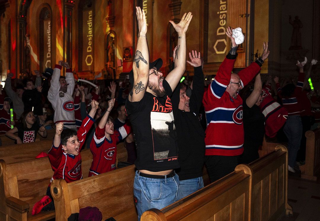 Fans cheer as they watch the Montreal Canadiens win 3-2 in overtime against the Tampa Bay Lightning during NHL playoff hockey action in the Cathedral of Saint-Jean-l'Evangeliste in Saint-Jean-sur-Richelieu, Quebec, 2026. The Canadian Press/Edouard Desroches