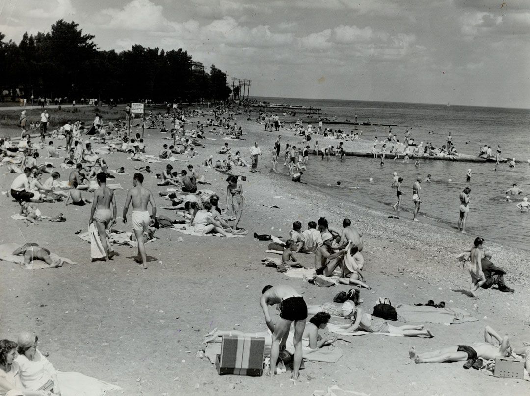 Crowded beach is on the lake side of Centre Island; a popular spot as Toronto's thousands sought cooling breezes and water as they enjoyed the line; hot week-end weather. Ideal summer weather lured huge crowds to all of Toronto's beaches and sent other thousands driving out into the country for picnics and other country activities. | Toronto Star Archives/Toronto Star via Getty Images